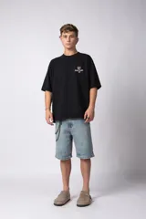 Remera de corte oversize color gris oscuro, confeccionada en algodón premium de alto gramaje. Presenta un diseño minimalista con un pequeño estampado frontal que incluye un oso y el texto 'Richer & Louder VCP'.