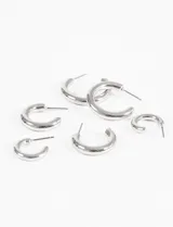 Set de tres pares de aros tipo argolla gruesa (bold) de diferentes tamaños. Son de color plateado y tienen un acabado liso y brillante.
