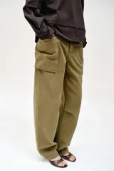 Camiseta oversize de cuello redondo y manga larga con puños abotonados. Confeccionada en algodón, presenta un diseño con combinación de tejidos a tono y bajo asimétrico.