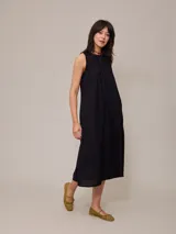 Vestido largo negro sin mangas, de corte recto y cuello redondo.