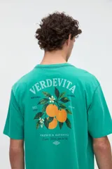 Remera de manga corta color verde, con calce relaxed y estampa en la espalda con diseño de naranjas y texto "Verdevita".