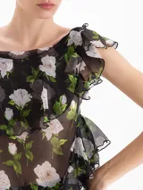 Top asimétrico de seda con estampado floral, bretel para anudar en un hombro, manga fluida y volados en el escote y laterales.