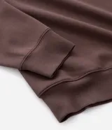 Buzo de pijama con capucha ajustable y cordones, confeccionado en tejido de modal con acabado suave. Presenta mangas largas, puños y ruedo acanalados, ofreciendo un calce holgado y confortable.