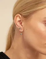 Aro piercing plateado con forma de ojo y cristal Swarovski color zafiro claro.