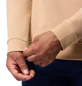 Buzo de cuello redondo Columbia, color beige, con puños y dobladillo acanalados. Presenta un pequeño parche con el logo de la marca en el pecho.