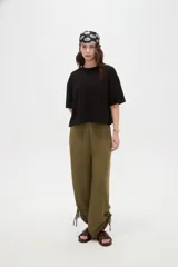 Remera blanca de manga corta, con cuello redondo a la base y diseño holgado.