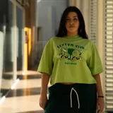 Remerón verde claro con estampa de dos pelotas de tenis con brazos y piernas, y texto "Septum Clvb" en verde oscuro.