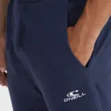 Pantalón de jogging azul marino con cintura elástica ajustable con cordón, corte ajustado y logo pequeño estampado en blanco en el muslo izquierdo.