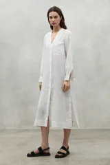 Vestido túnica blanco de lino con botones, manga larga, cuello en V y un bolsillo en el pecho.