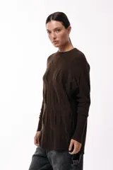 Sweater de punto con textura geométrica, de calce relajado, cuello redondo y mangas largas con puños ajustados.