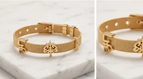 Pulsera de acero italiano con baño de oro, diseño de malla metálica con dijes colgantes del Árbol de la Vida y la palabra 'life', decorada con barras de circonias.