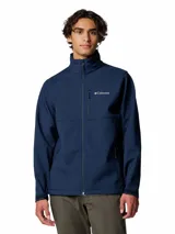 Campera softshell Columbia modelo Ascender, color azul marino, con cuello alto, cierre frontal completo, bolsillos laterales y en el pecho con cierre, y puños ajustables.