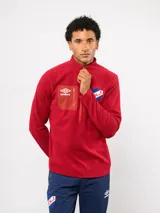 Buzo de micropolar azul con medio cierre frontal, cuello alto y bolsillo con cierre en el pecho. Presenta el logo de Umbro y el escudo del Club Nacional de Football.
