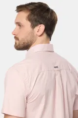 Camisa lisa de manga corta color crema, confeccionada en 100% algodón, con cuello abotonado y un bolsillo en el pecho.