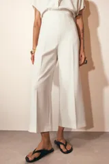 Pantalón culotte de tiro alto y pierna ancha, con cierre lateral mediante cremallera oculta.