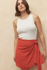 Minifalda negra con diseño cruzado y lazo lateral.