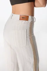 Pantalón de pierna ancha con acabado brillante, confeccionado en lino. Presenta un diseño de tiro medio con cierre de botón y cremallera, bolsillos traseros y etiqueta de marca en la cintura.