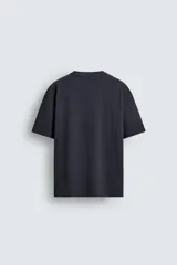 Camiseta de corte relajado confeccionada en algodón con textura irregular, cuello redondo y manga corta.