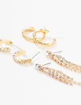 Set de tres pares de aros plateados: un par de aros tipo argolla con textura, un par de aros colgantes con strass y un par de aros tipo argolla trenzados.