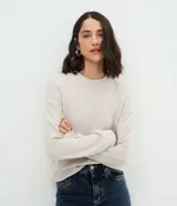 Blusa básica de manga larga con cuello redondo y puños ajustados, confeccionada en tejido de algodón y poliéster. Presenta un corte regular anatómico y diseño liso sin estampas.