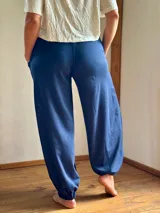 Conjunto de dos piezas color azul marino, compuesto por una remera de manga tres cuartos con escote en V y una babucha de tiro alto con bolsillos laterales y puños elastizados.