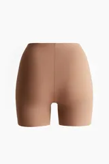Culotte de tiro alto color tostado, confeccionado en punto elástico supersuave con diseño moldeador.