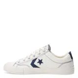 Championes Converse modelo Star Player OX, de corte bajo, confeccionados en lona color blanco con detalles en azul marino, incluyendo el logo de estrella y flecha característico en los laterales.