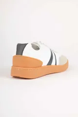 Championes deportivos para mujer Paddock modelo Aegon, con diseño en color blanco, detalles en beige y marrón tostado, y franjas laterales oscuras. Cuenta con suela de goma color camel y cordones blancos.