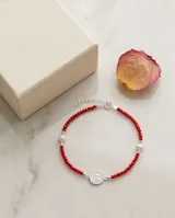Pulsera de cuentas de cristal rojas con medalla central de San Benito en plata 925.