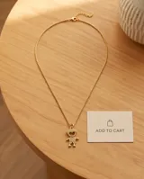 Collar de bronce dorado con cadena fina y dije en forma de silueta de niño adornado con circónias.