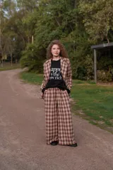 Pantalón de paño tiro alto de corte ancho y holgado, con estampado a cuadros en tonos marrones y beige.