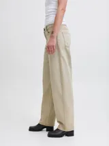 Jean de corte barrel fit con tiro medio, confeccionado en denim de sarga con un lavado teñido en tono beige. Presenta pierna suelta, cierre con bragueta y diseño de cinco bolsillos.