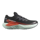 Championes de trail running Salomon DRX Defy Grvl, color negro con detalles en naranja y entresuela verde menta, diseñados con soporte y ligereza para correr en caminos de grava y asfalto.