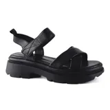 Sandalias de cuero color beige con plataforma track y tiras cruzadas.