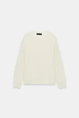 Jersey de punto con cuello redondo y manga larga, confeccionado en lana 100% con acabados en rib.