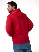 Buzo con capucha y cierre frontal completo, confeccionado en tejido fleece color rojo. Presenta bolsillos tipo canguro, puños y cintura acanalados, y un pequeño parche con el logo de la marca en el bajo.