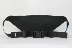 Riñonera de nylon color verde con detalles en negro. Presenta una cinta superior con la inscripción 'Boston Celtics' repetida y el logo del equipo estampado en la parte inferior derecha. Cuenta con cierre frontal y correa regulable.