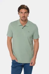 Remera polo de piqué en color azul con estampado de mini print geométrico en toda la prenda. Presenta cuello clásico, cierre frontal con botones personalizados y logo bordado en el pecho.