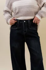 Jean wide leg de tiro alto con calce relajado y pierna amplia. Confeccionado en denim con leve desgaste, cuenta con cintura definida con presillas, bolsillos clásicos y cierre frontal con botón metálico.