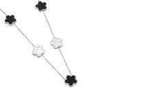 Collar de acero plateado con cinco dijes en forma de trébol, alternando nácar blanco y ónix negro.