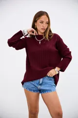 Sweater de tejido de punto acanalado en color bordó, con cuello redondo y mangas largas. Presenta un corte holgado y cómodo.