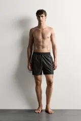 Short de baño negro de tejido técnico, con cintura elástica ajustable con cordón, bolsillos laterales y forro interior, perteneciente a la colección especial Aaron Levine x Zara.
