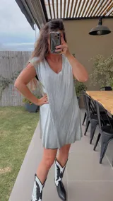 Vestido corto plateado con escote en V y mangas cortas.
