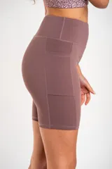 Short tipo biker de tiro alto, confeccionado en tejido técnico elástico de secado rápido, con costuras reforzadas y bolsillos laterales integrados.