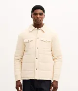 Campera puffer de Marfinno confeccionada en tejido de cotelé de algodón, con diseño acolchado, cuello inglés, cierre frontal con botones y dos bolsillos con solapa en el pecho.
