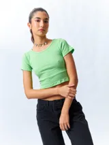Remera cropped color verde claro, de manga corta y cuello redondo.