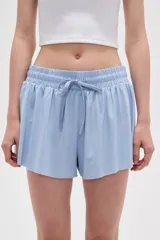 Short de poliéster color negro, de calce holgado y tiro alto, con cintura elástica y cordón ajustable.