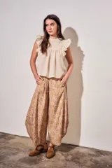 Babucha fluida de tiro alto con cintura elástica, diseño de rayas combinadas con estampado tipo toile de jouy en tonos beige y rojo.