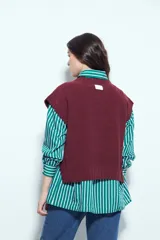 Chaleco tejido sin mangas de color negro, con cuello redondo y diseño de textura sutil. Presenta un corte recto con terminaciones acanaladas en el ruedo y hombros levemente estructurados.