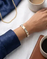 Esclava rígida de plata 925 con aplique de lámina de oro 18k, decorada con tres incrustaciones circulares de piedras azules.